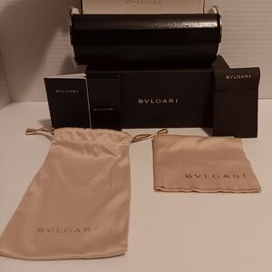 5 piece bvlgari eyeglass case set. Eyeglass case had dents, the cloth has spots